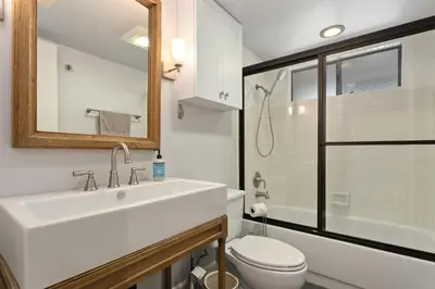 a white bathroom with a sink and a toilet at Vista Pacific - DM1050 in Del Mar