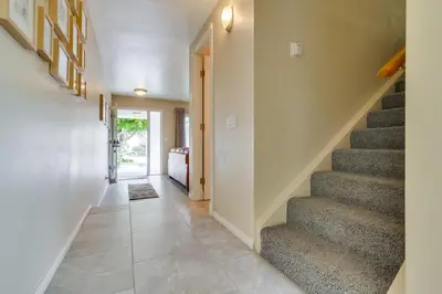 a hallway with stairs in a house at Bare Feet &Salty Hair-DMBC141S in Solana Beach