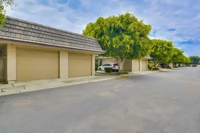 an empty parking lot in front of a house at Bare Feet &Salty Hair-DMBC141S in Solana Beach