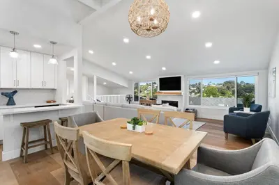 a kitchen and dining room with a wooden table and chairs at Cast-a-Waves - SUR29 in Solana Beach