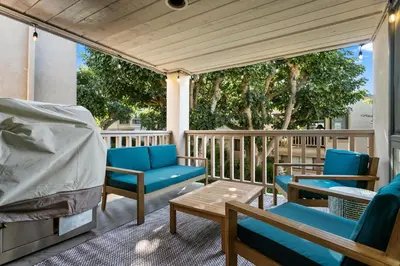a porch with chairs and a bed and a table at Cast-a-Waves - SUR29 in Solana Beach