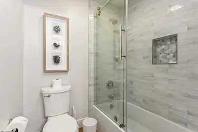 a white bathroom with a shower and a toilet at Cast-a-Waves - SUR29 in Solana Beach
