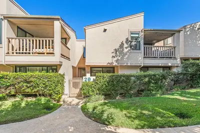 an apartment building with a balcony and grass at Cast-a-Waves - SUR29 in Solana Beach