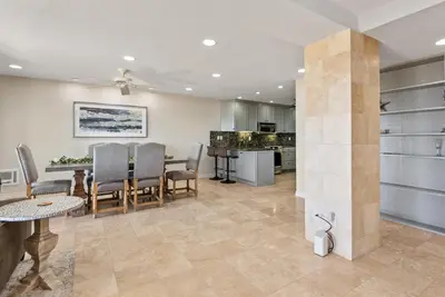 a kitchen and living room with a table and chairs at Barefoot Oasis - SUR127 in Solana Beach