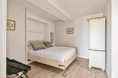 a white bedroom with a bed and a window at Barefoot Oasis - SUR127 in Solana Beach