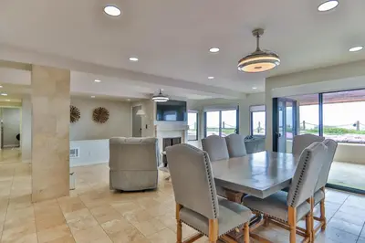 a dining room with a table and chairs at Barefoot Oasis - SUR127 in Solana Beach