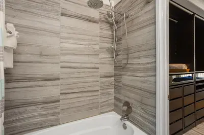 a bathroom with a bath tub and a shower at Shore O'Clock - SBTC149 in Solana Beach