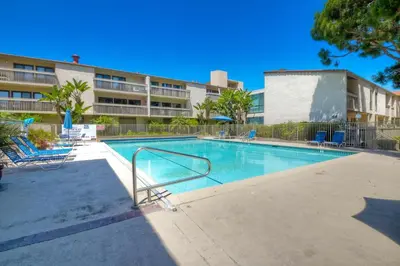 a swimming pool in front of a apartment building at Shore O'Clock - SBTC149 in Solana Beach