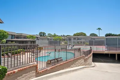 a swimming pool with a fence around it at Drift Away - DMBC884 in Solana Beach