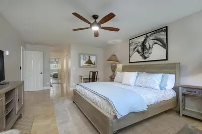 a bedroom with a bed and a ceiling fan at Casa Del Sol - SUR46 in Solana Beach