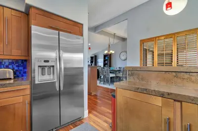 a kitchen with a stainless steel refrigerator at Casa Del Sol - SUR46 in Solana Beach