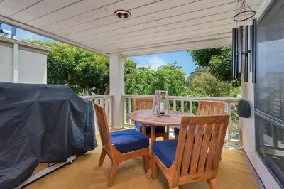 a porch with a table and chairs on a porch at Casa Del Sol - SUR46 in Solana Beach