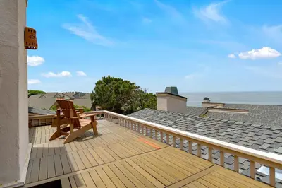a wooden deck with a chair on top of a house at Casa Del Sol - SUR46 in Solana Beach