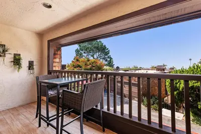 a patio with a table and chairs on a balcony at Torrey View Hideaway in San Diego