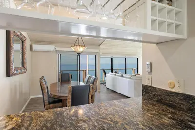 a dining room with a table and a view of the ocean at Sea For Miles - SUR93S in Solana Beach