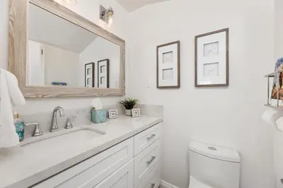 a white bathroom with a sink and a mirror at Solana Escape - SUR44 in Solana Beach