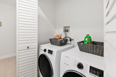 a laundry room with a washer and dryer at Solana Escape - SUR44 in Solana Beach
