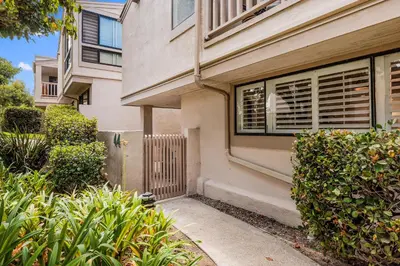 a house with a window and bushes in front of it at Solana Escape - SUR44 in Solana Beach
