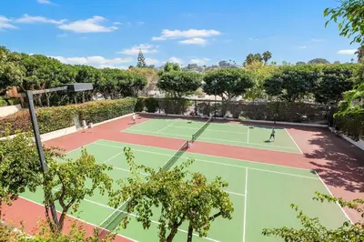 two tennis courts with people playing on them at Sunset Retreat - SUR105 in Solana Beach