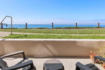 a balcony with chairs and a view of the ocean at Sunset Retreat - SUR105 in Solana Beach