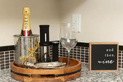 a bottle of wine and a wine glass on a counter at Tide and True - SUR129S in Solana Beach