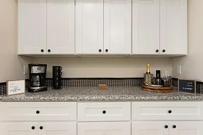 a kitchen with white cabinets and a counter top at Tide and True - SUR129S in Solana Beach