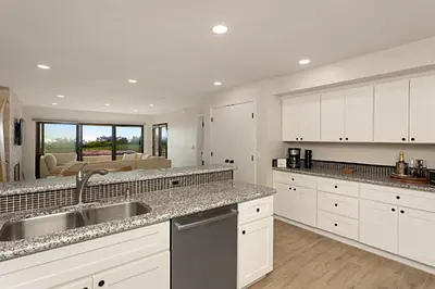 a kitchen with white cabinets and a sink at Tide and True - SUR129S in Solana Beach