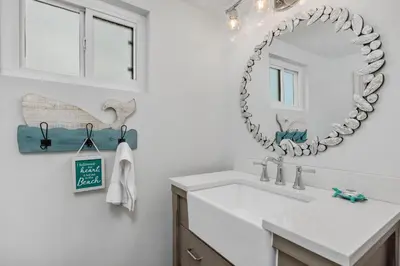 a bathroom with a sink and a mirror on the wall at Salty Shores - SUR108 in Solana Beach