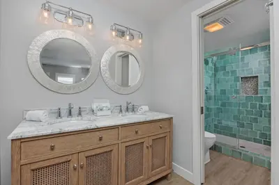 a bathroom with a sink and a mirror at Salty Shores - SUR108 in Solana Beach