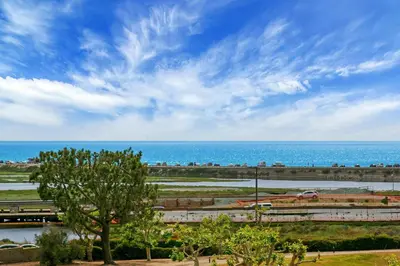 a view of the ocean with a train in the distance at Mermaid's Lookout in San Diego