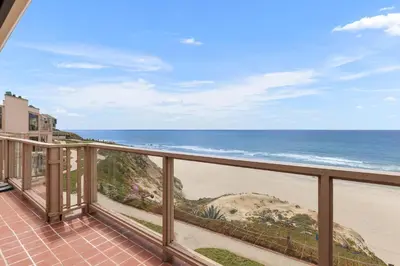 a balcony with a view of the beach at King of the Beach - SUR79 in Solana Beach