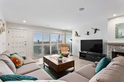 a living room with two couches and a television at Sea Gem - SBTC119 in Solana Beach