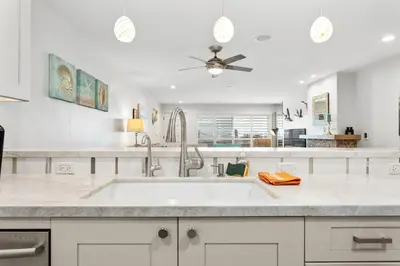 a kitchen with a sink and a ceiling fan at Sea Gem - SBTC119 in Solana Beach