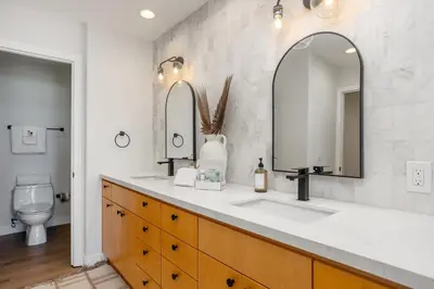 a bathroom with a sink and two mirrors at Ocean Whisper - SBTC238 in Solana Beach