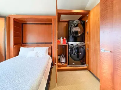 a small bedroom with a bed and a washing machine at Enchanting Oasis - SONG72 in Solana Beach