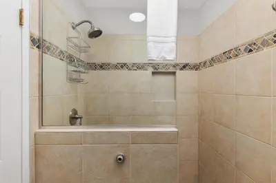 a bathroom with a shower with a tub at Seaside Splash - SBTC169 in Solana Beach
