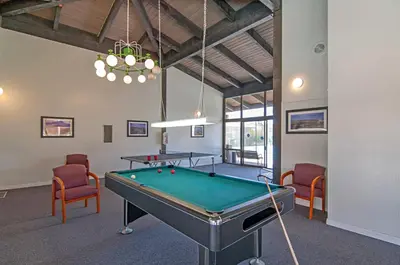 a billiard room with a pool table and chairs at Seaside Splash - SBTC169 in Solana Beach