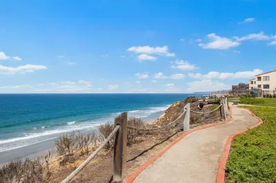 a path to the beach with the ocean in the background at Coastal Retreat- SUR33 in Solana Beach