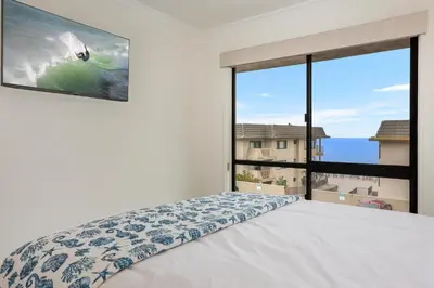 a bedroom with a bed and a large window at Pacific Bliss - DMBC767 in Solana Beach