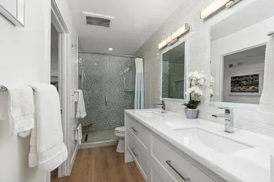 a white bathroom with a sink and a shower at Fairway Haven - CB2507 in Carlsbad