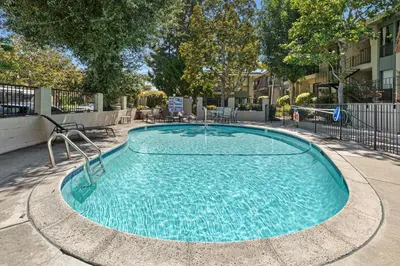a swimming pool with a fountain in a courtyard at Fairway Haven - CB2507 in Carlsbad