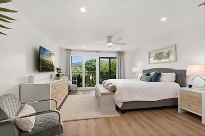 a white bedroom with a bed and a window at Fairway Haven - CB2507 in Carlsbad