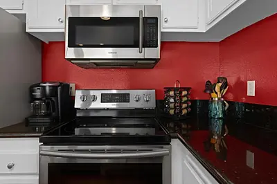 a kitchen with a stove and a microwave at Sea Den - DMST45 in Solana Beach