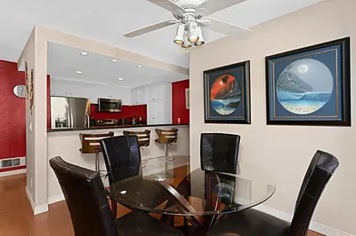 a dining room with a glass table and black chairs at Sea Den - DMST45 in Solana Beach