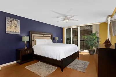 a bedroom with a bed and a blue wall at Sea Den - DMST45 in Solana Beach