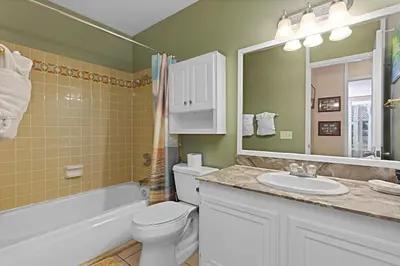 a bathroom with a toilet and a sink and a mirror at Sea Den - DMST45 in Solana Beach