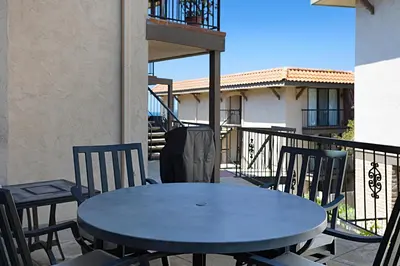 a blue table and chairs on a balcony at Sea Den - DMST45 in Solana Beach