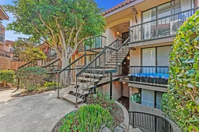an apartment building with stairs and a tree at Whale Watch - DMST12 in Solana Beach