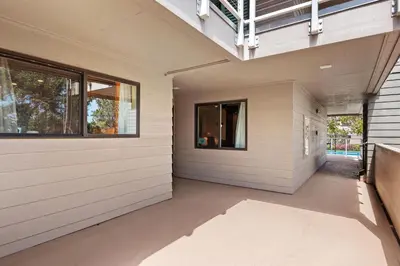 a hallway of a house with white siding at Villa del Pacifico - SONG20 in Solana Beach