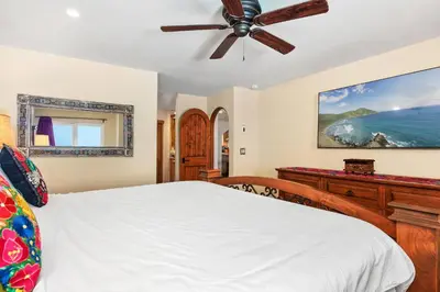 a bedroom with a bed and a ceiling fan at Villa del Pacifico - SONG20 in Solana Beach